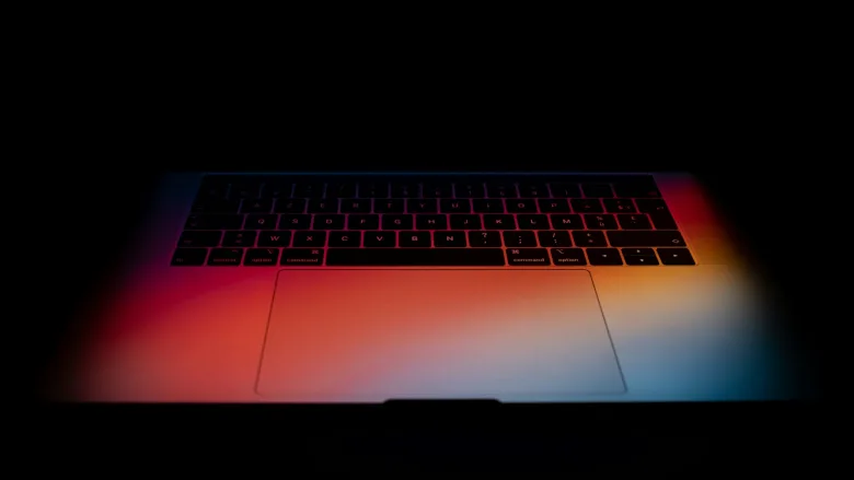 Laptop keyboard in gradient colorful light
