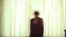 Blurry person behind curtain 
