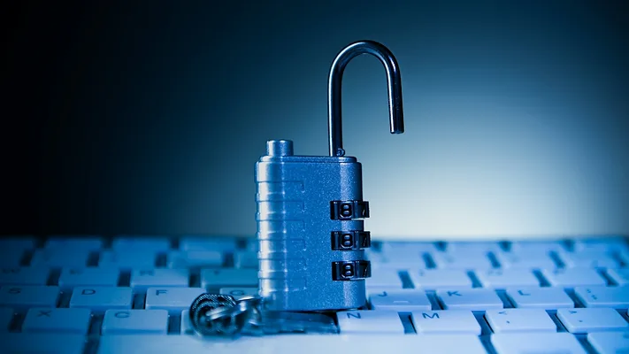 Opened padlock on computer keyboard Opened padlock on computer keyboard