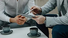Two men working on a tablet