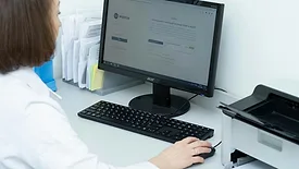 Person using computer at medical facility