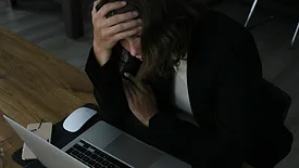 Stressed woman at laptop