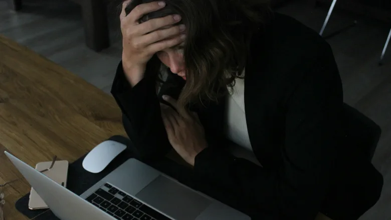Stressed woman at laptop