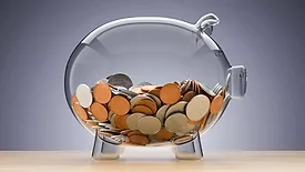 Glass piggy pank with coins