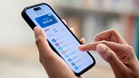 Close-up on a woman using a banking app on her cell phone